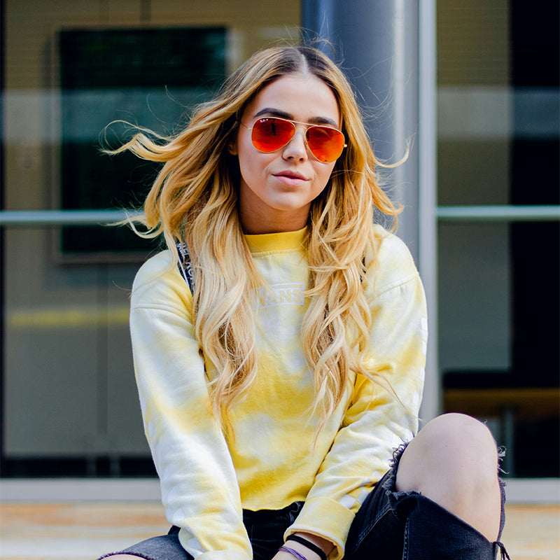 Red gold-framed sunglasses are fashionable