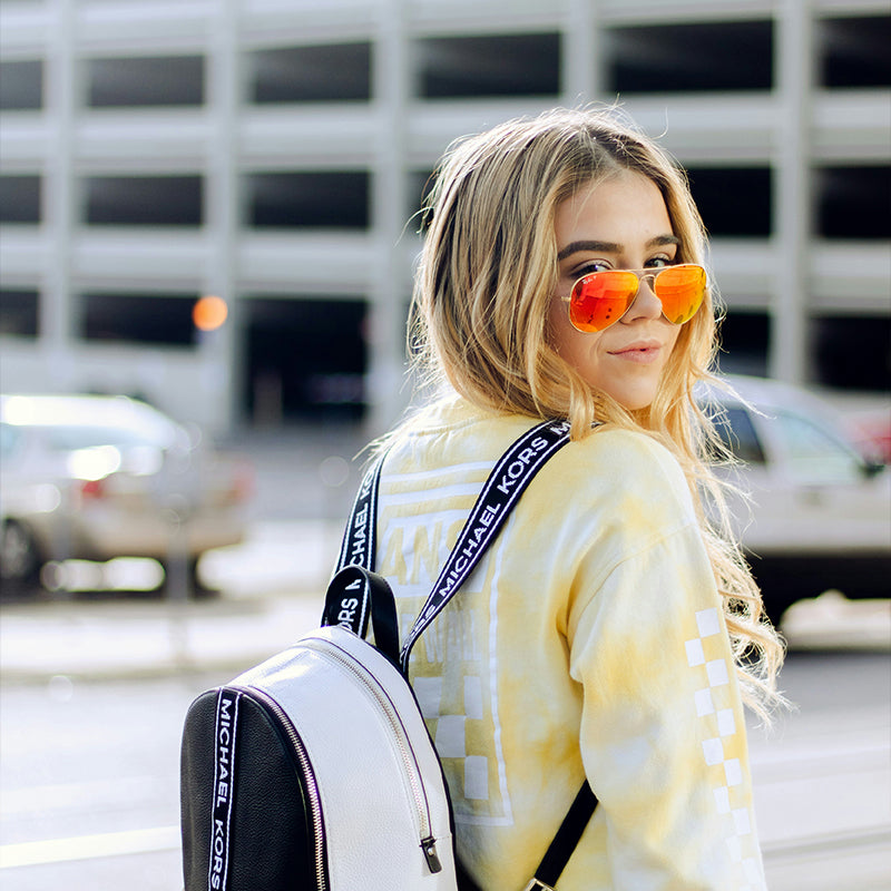 Red gold-framed sunglasses are fashionable