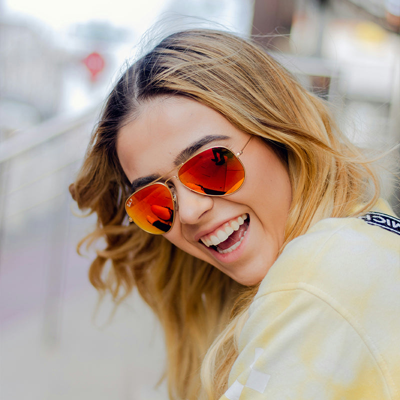 Red gold-framed sunglasses are fashionable