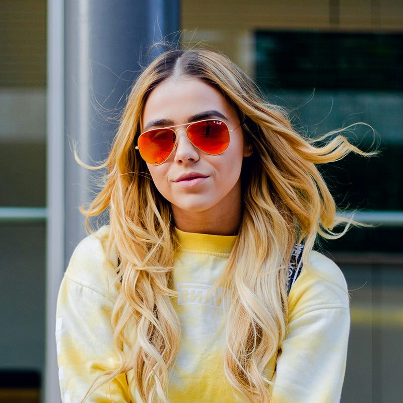 Red gold-framed sunglasses are fashionable