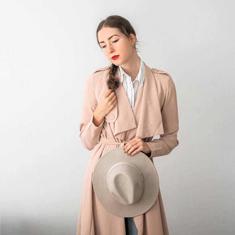 Long pink trench coat draped in soft leather